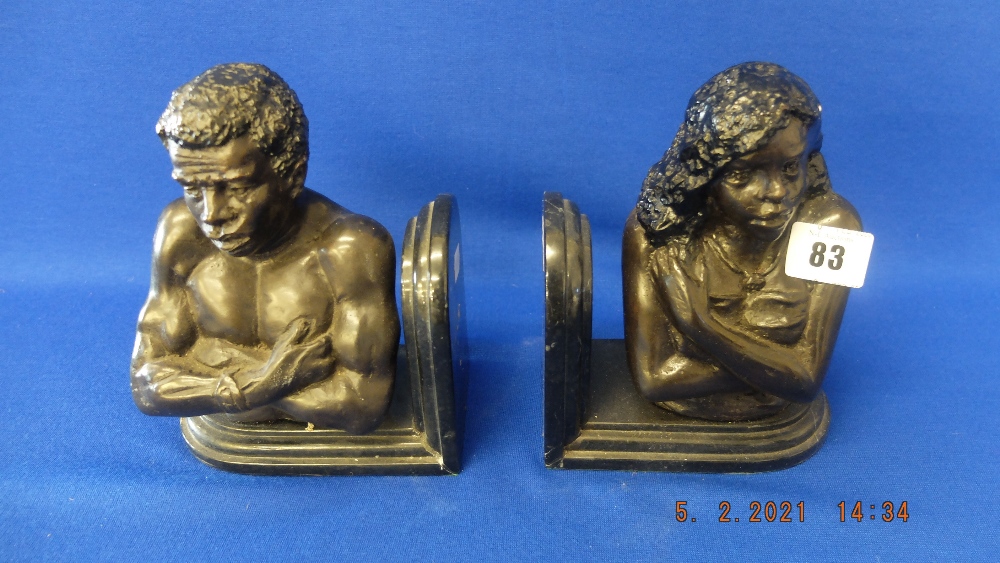 A pair of bronze African bookends