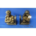 A pair of bronze African bookends