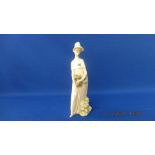 An early Lladro figure of a lady holding a small dog