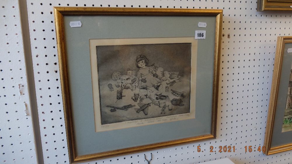 A framed etching of a child with toys dated 86
