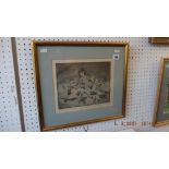 A framed etching of a child with toys dated 86