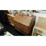 An oak bureau with three drawers