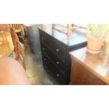 A modern black four drawer chest,