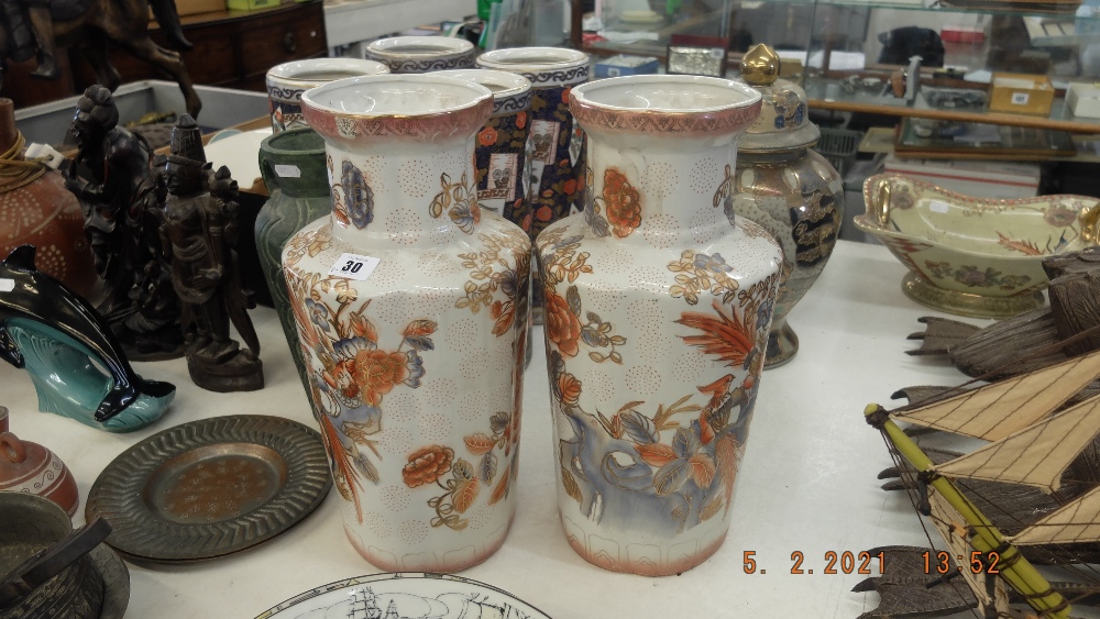 A pair of orange and white vases