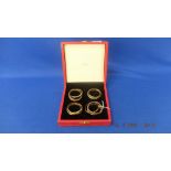 A set of four Trinity napkin rings in Original box by Cartier