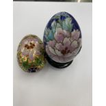 Two enamel and gilt floral decorated eggs