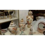 A pair of Orange and white temple jars plus a larger lidded temple jar