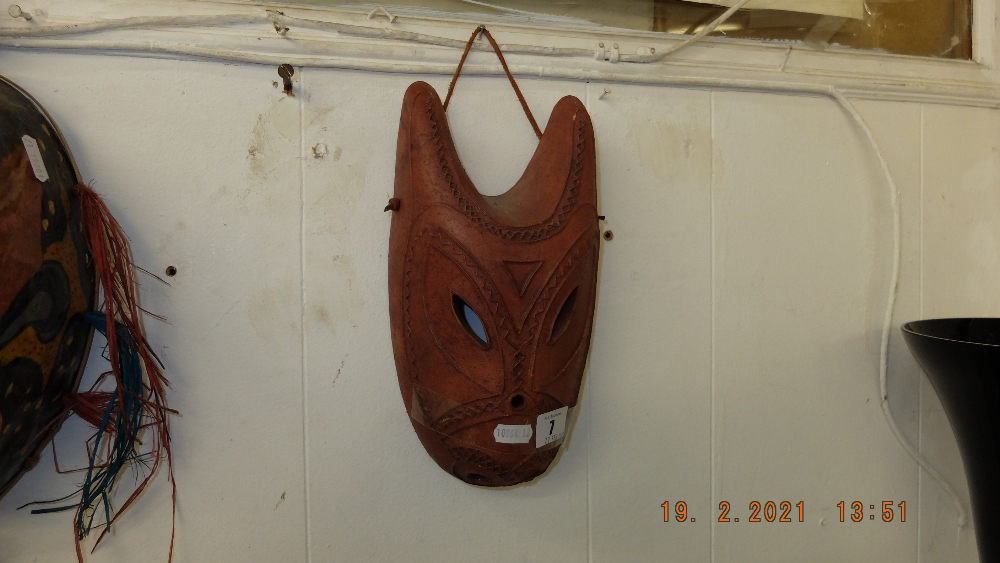 A Terracotta African mask signed Mandana inside