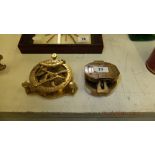 Two brass compasses one with a sundial