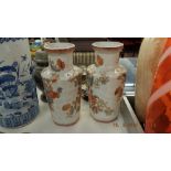 A pair of orange and white vases