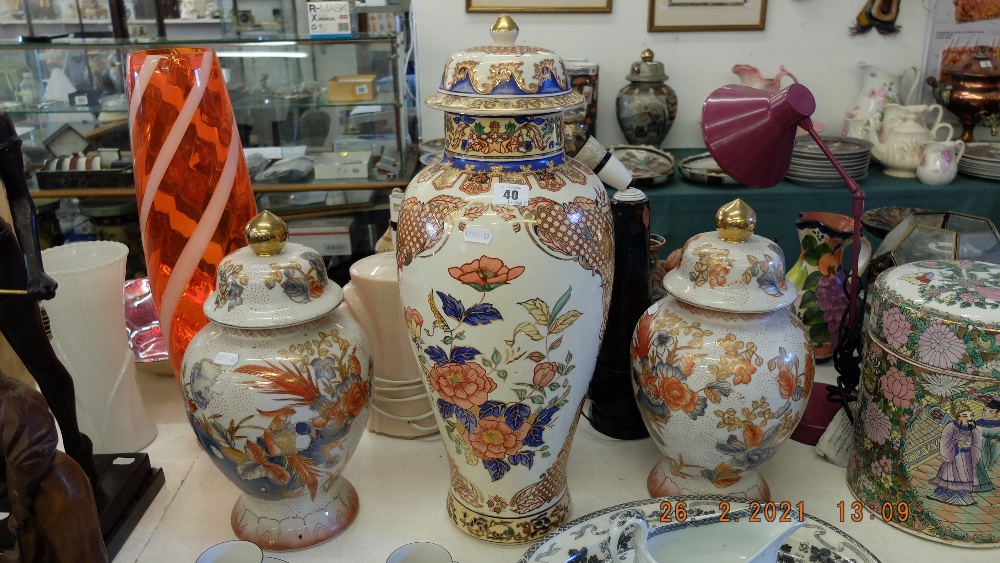 A pair of Orange and white temple jars plus a larger lidded temple jar