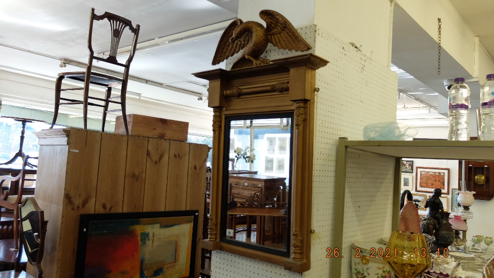 A gilt framed mirror with Eagle