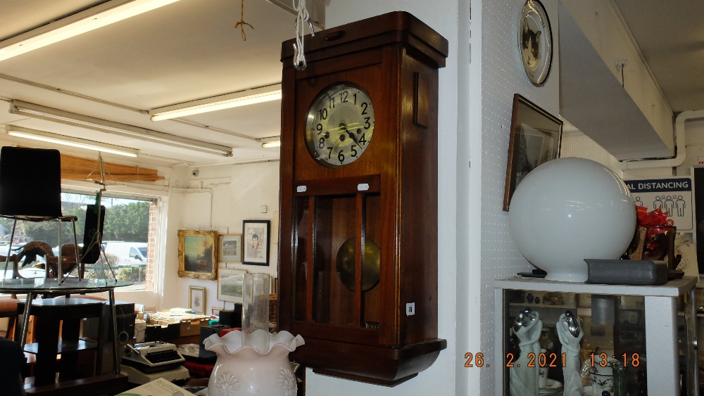 An oak cased wall clock