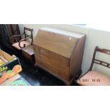 An oak bureau with three drawers