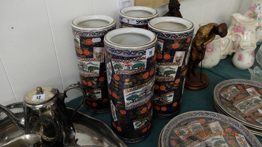 Four Imari style cylindrical vases