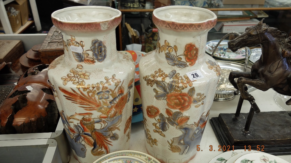 A pair of orange and white vases