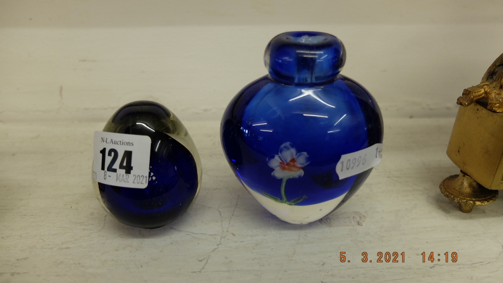 A blue paperweight and a blue floral vase