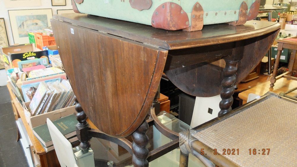 An oak barley twist drop flap table