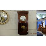 An oak cased wall clock