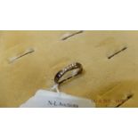 A hallmarked 9ct gold eight stone diamond ring