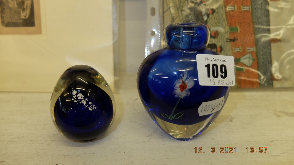 A blue paperweight and a blue floral vase