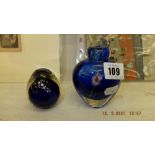 A blue paperweight and a blue floral vase