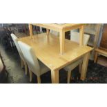 A light teak dining table and four chairs