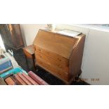 An oak bureau with three drawers