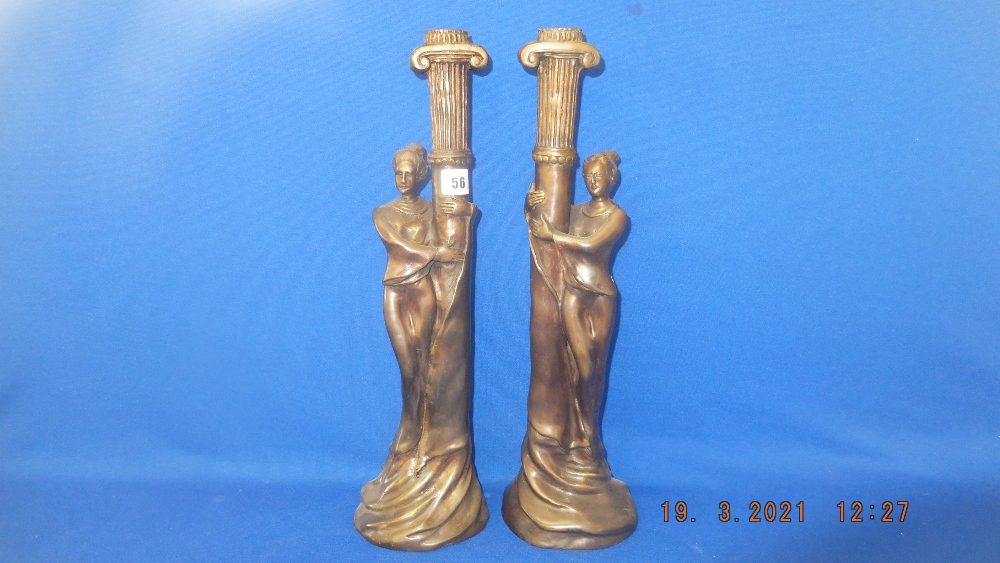 A pair of bronze lady candlesticks