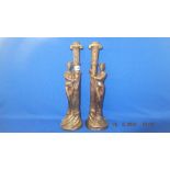 A pair of bronze lady candlesticks