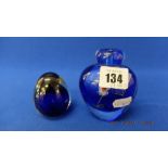 A blue paperweight and a blue floral vase