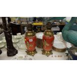 A pair of oil lamps with oriental design to base including shades