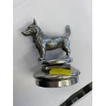 An old car mascot in the form of a Terrier