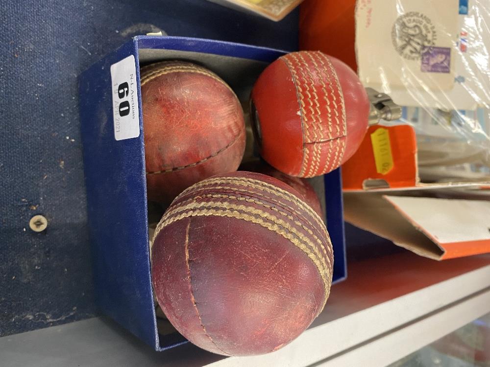 A cricket ball lighter and two cricket balls