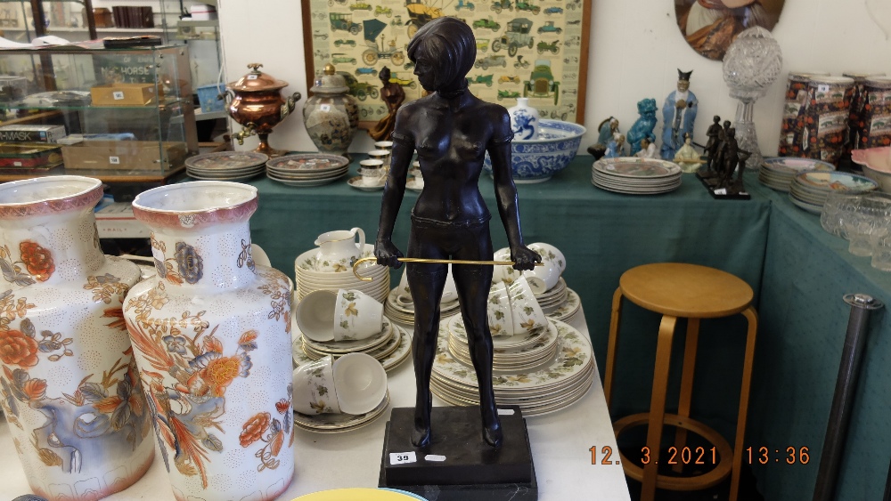 A bronze lady with cane