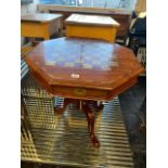 A brass inlaid pedestal games table