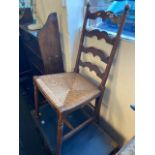 An Oak book shelf and ladder back chairs