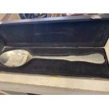 A boxed pewter serving spoon