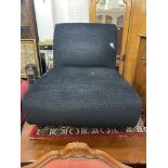 A small black upholstered chair