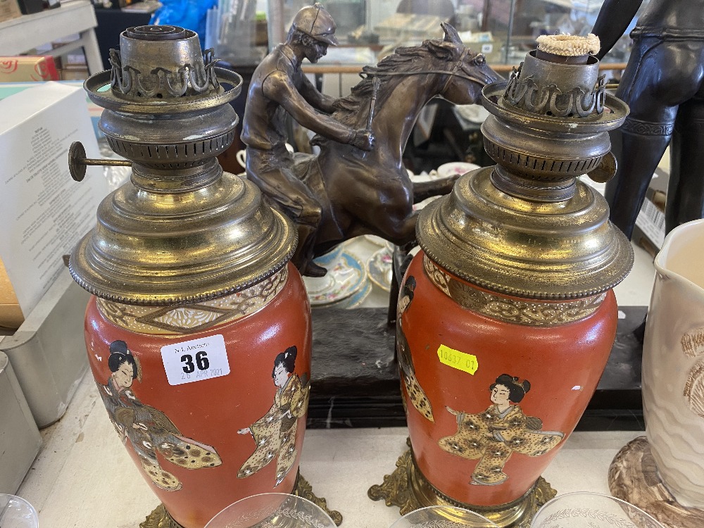 A pair of continental oil lamps