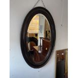 An oval Mahogany mirror