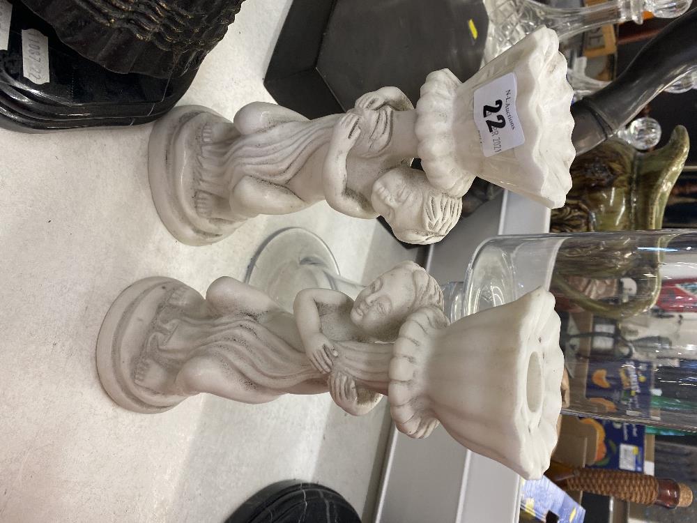 A pair of marble Cherub candlesticks