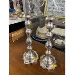 A pair of hallmarked silver candlesticks- not filled,