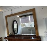 A large pine framed mirror
