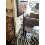 A Victorian wrought iron lamp stand