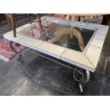 A wrought iron and stone coffee table