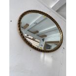An Oval gilt framed mirror