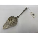 An ornate carved silver spoon,