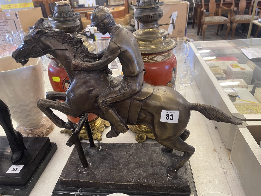 A bronze Racehorse/ Jockey statue,