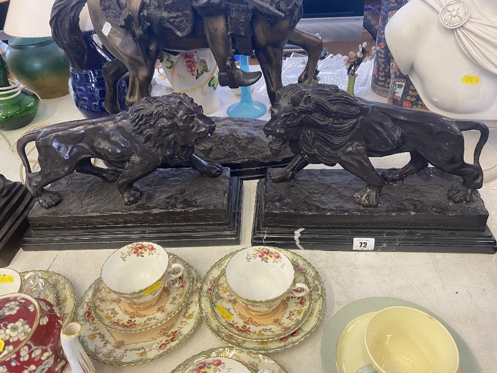 A pair of bronze lions on bases